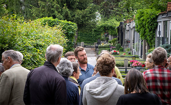 Gemeinsam mit Gärtnermeister Stefan Oberklammer sind Vertreter*innen von Klimabündnispfarren am St. Barbara Friedhof unterwegs
